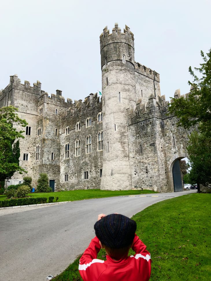 Kid in front of Kilkea Castle in Ireland