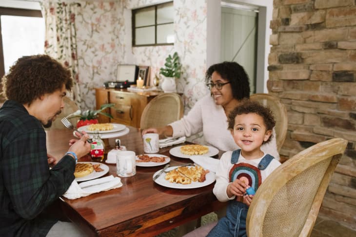 family eating breakfast together, child facing the camera