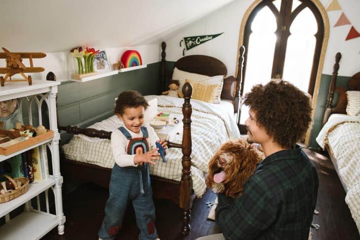 dad and child and dog playing together in kids bedroom