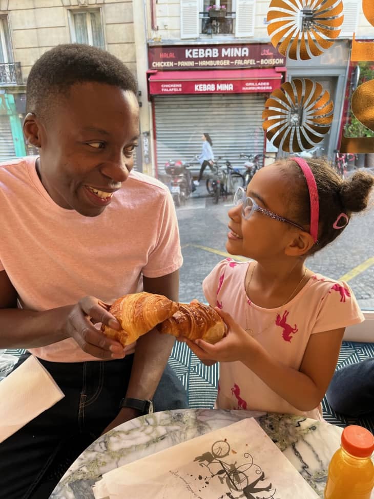 dad and daughter eating croissant