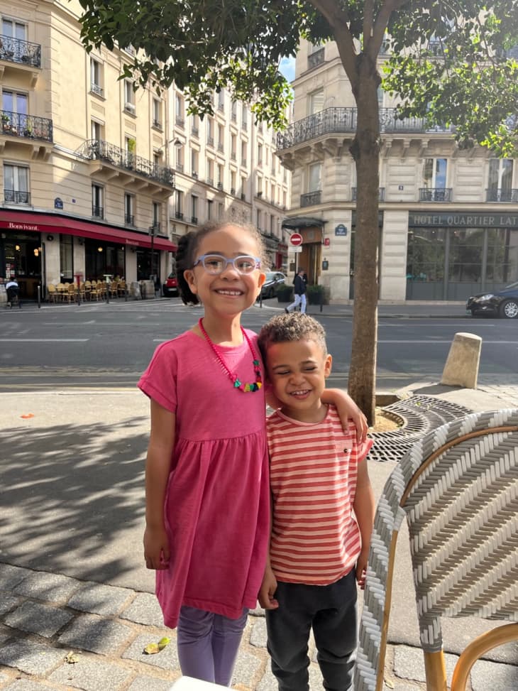 two kids standing in Paris