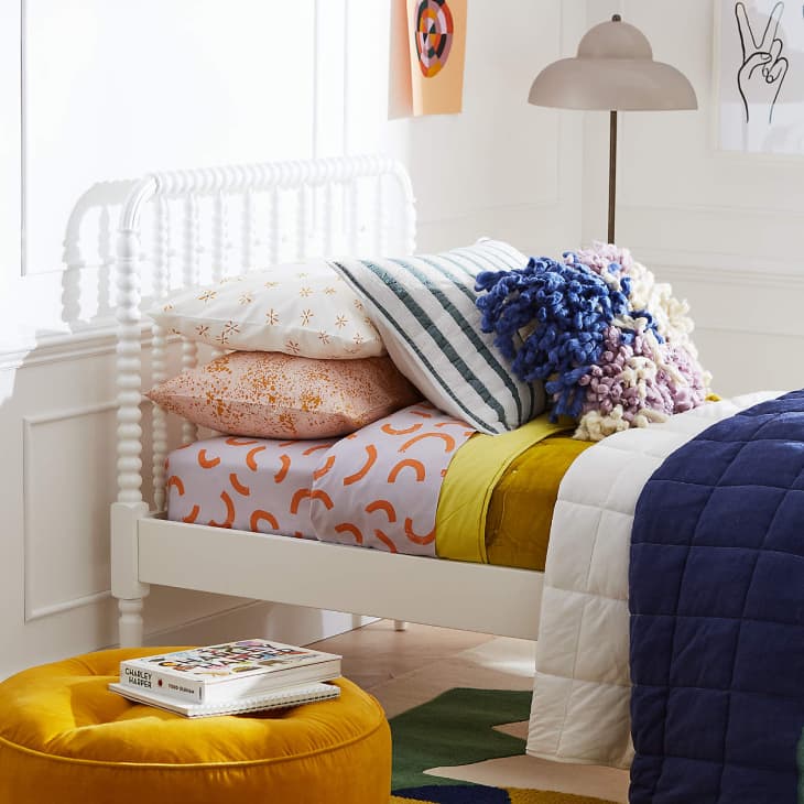 White jenny lind bed from crate &amp; kids with colorful blue yellow and pink bedding