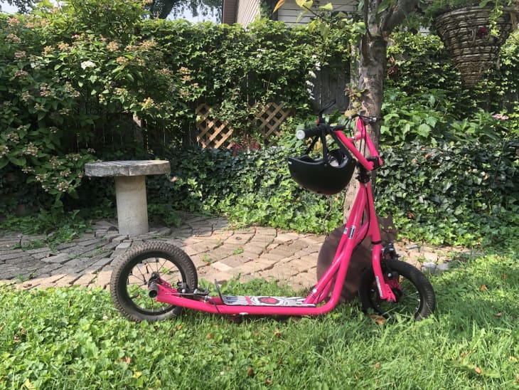 Hot pink mongoose expo youth scooter on green grass