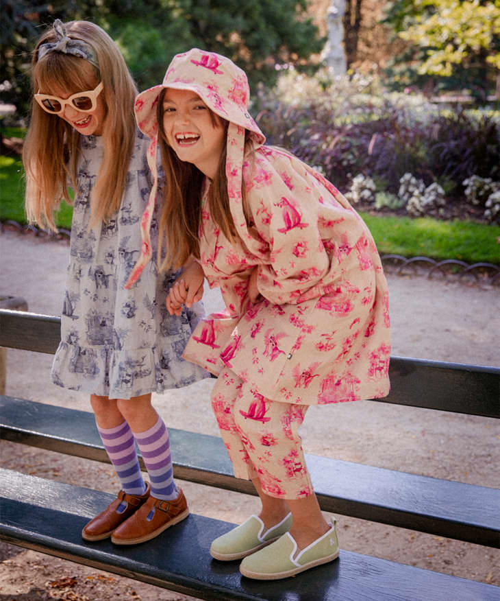 Two girls in flowery colorful Oeuf clothes