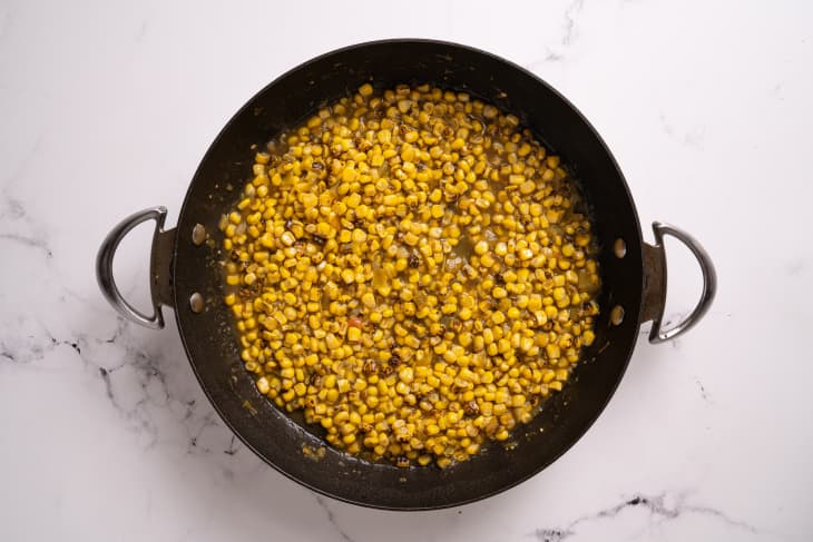 hatch chile salsa with corn in a black cast iron pan