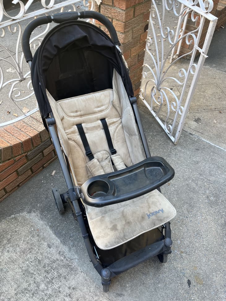 dirty joovy stroller on sidewalk