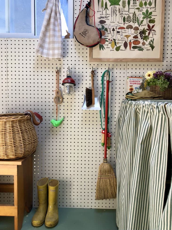 kids cleaning supplies hanging on a pegboard