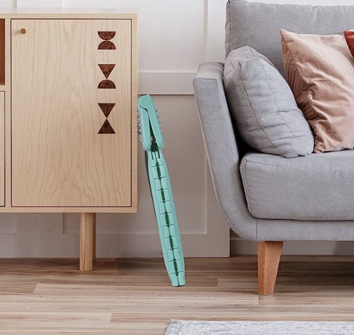 folded step stool between furniture