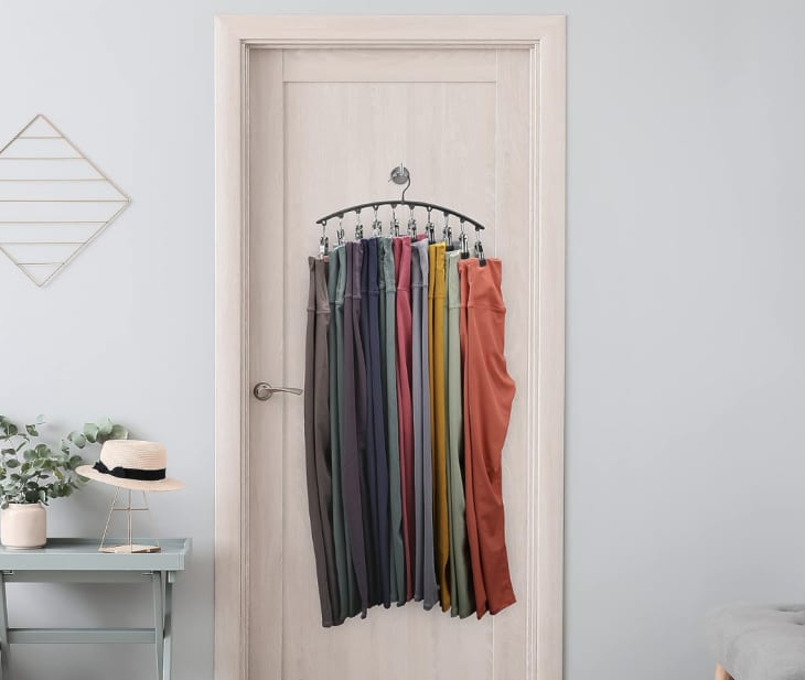hanger holding leggings against door