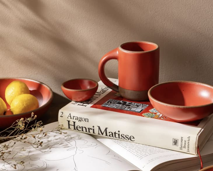 red stoneware dishes next to Henri Matisse book