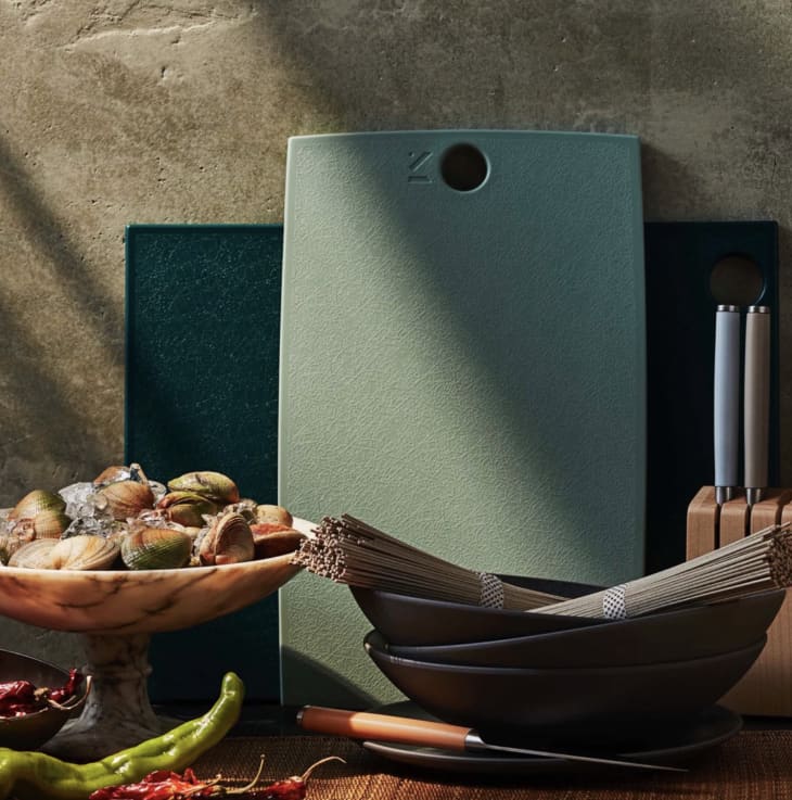 two green cutting boards with bowls, food, and cutlery
