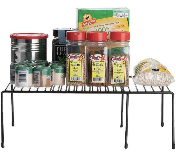 black Expandable Kitchen Shelf holding spices and pantry items
