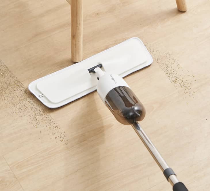white mop cleaning beige hardwood floor