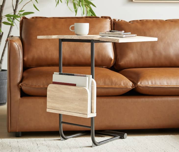 expandable black and beige side table in front of couch