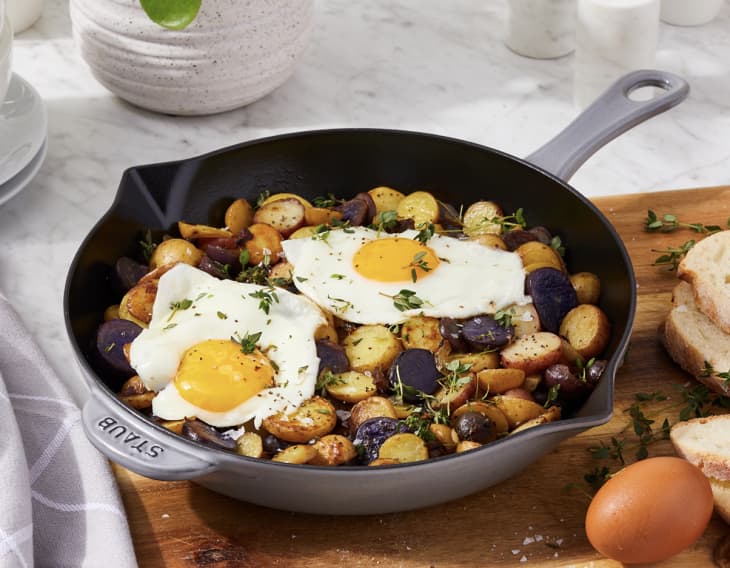 gray and black Enameled Cast Iron Fry Pan with eggs and potatoes