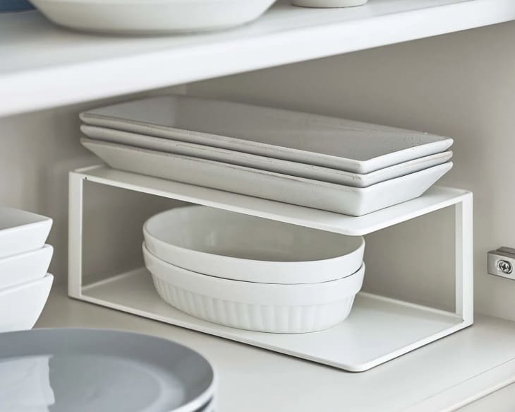 white Two-Tier Cabinet Organizer holding plates