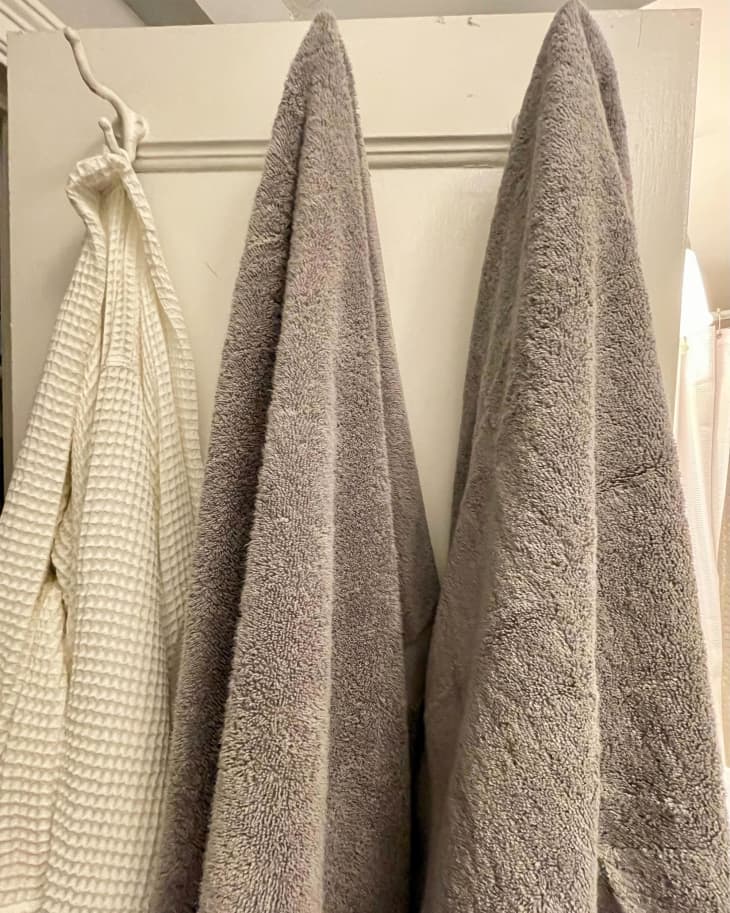 MIRACLE MADE towels hung in bathroom.
