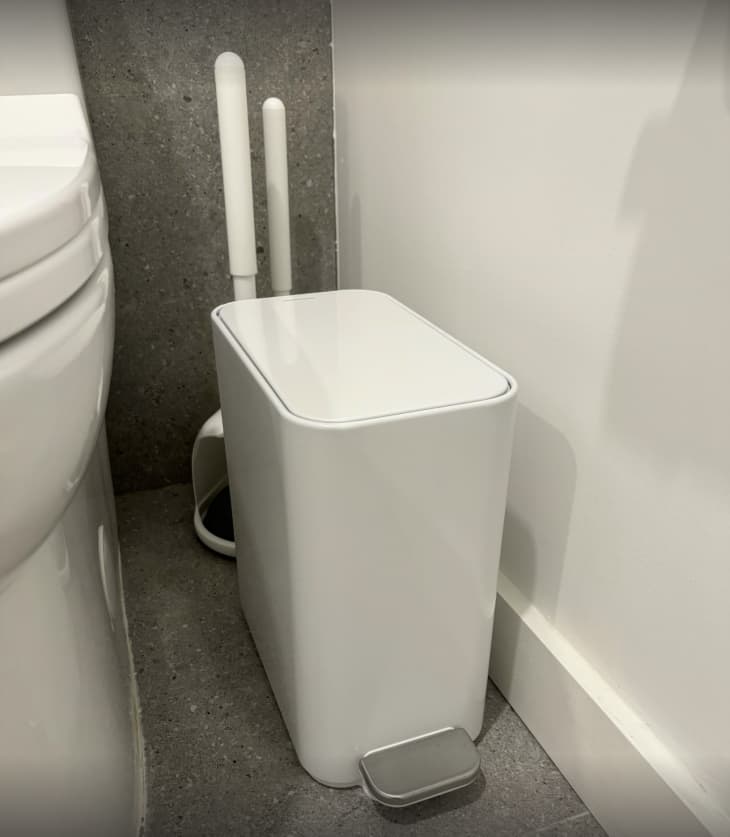 slim white trash can in bathroom