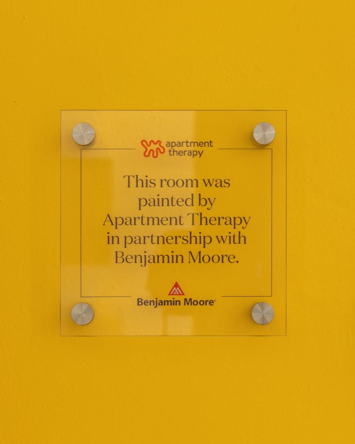 Signage placed in JQ International's office space with the phrase "This room was painted by Apartment Therapy in partnership with Benjamin Moore."
