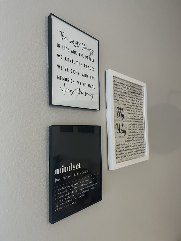 3 framed pieces of quote/inspiration art on gray wall