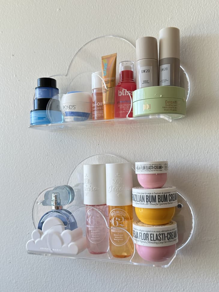 detail of cloud shaped clear acrylic shelves in dorm room holding perfume, toiletries
