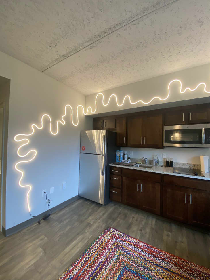 String lights are installed on the wall above the refrigerator.