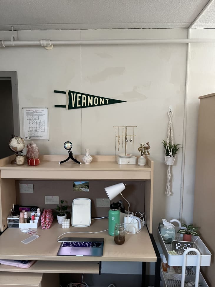 desk with upper shelf and push pin board on bottom back, Vermont triangle flag and desk knickknacks