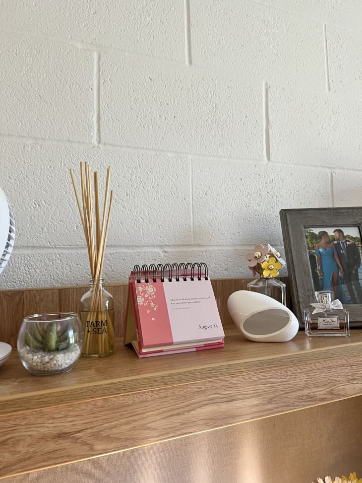 desk with incense, desk flip calendar and pictures