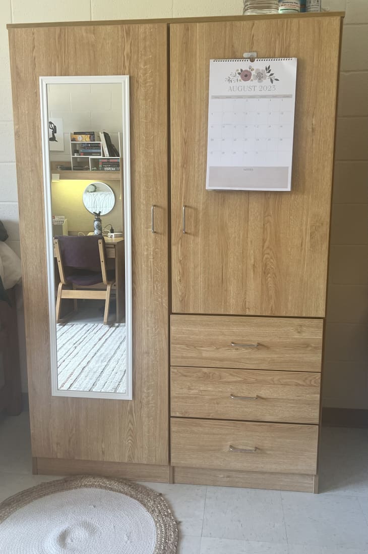wood wardrobe with hanging full length mirror on door