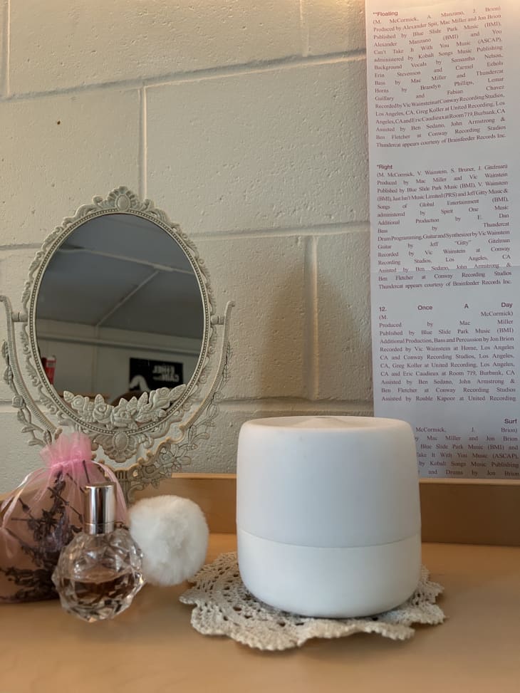 Mirror and perfume line shelf in dorm room.