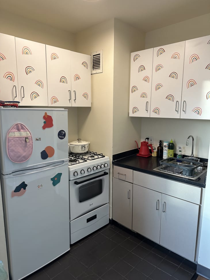 white dorm kitchen with rainbow decals on cabinets
