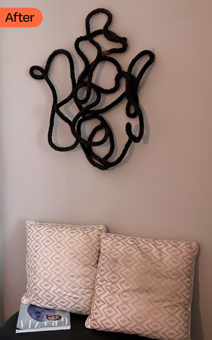 DIY Rope Wall Art: after photo of finished black rope art on wall above small black bench with 2 pillows, magazine