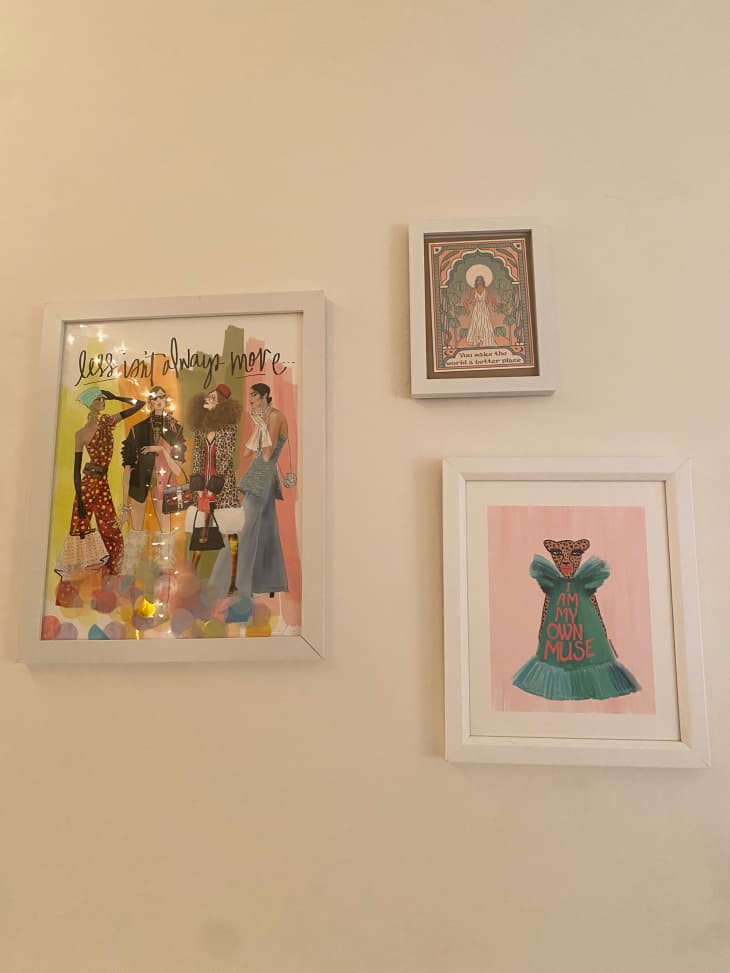 white wall with 3 framed pieces of artwork