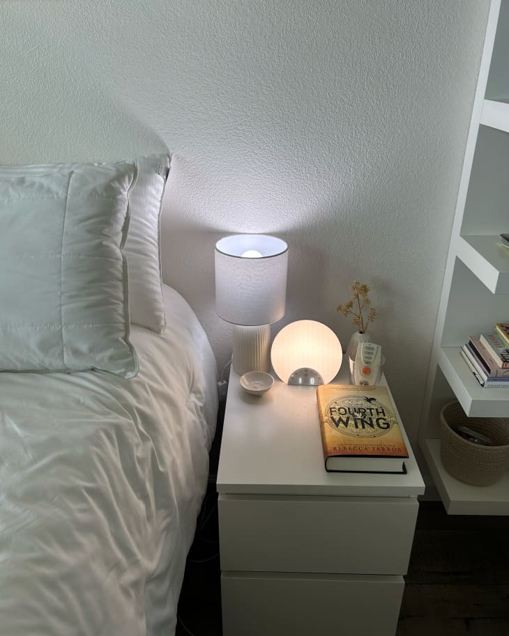 Dorm room with sunrise alarm clock lamp on bedside table