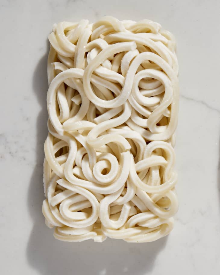a pile of udon noodles on a marble surface