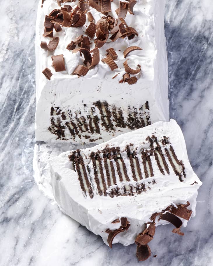 photo of an icebox cake with Oreo thins as the filling and chocolate curls as a topping on a marble surface