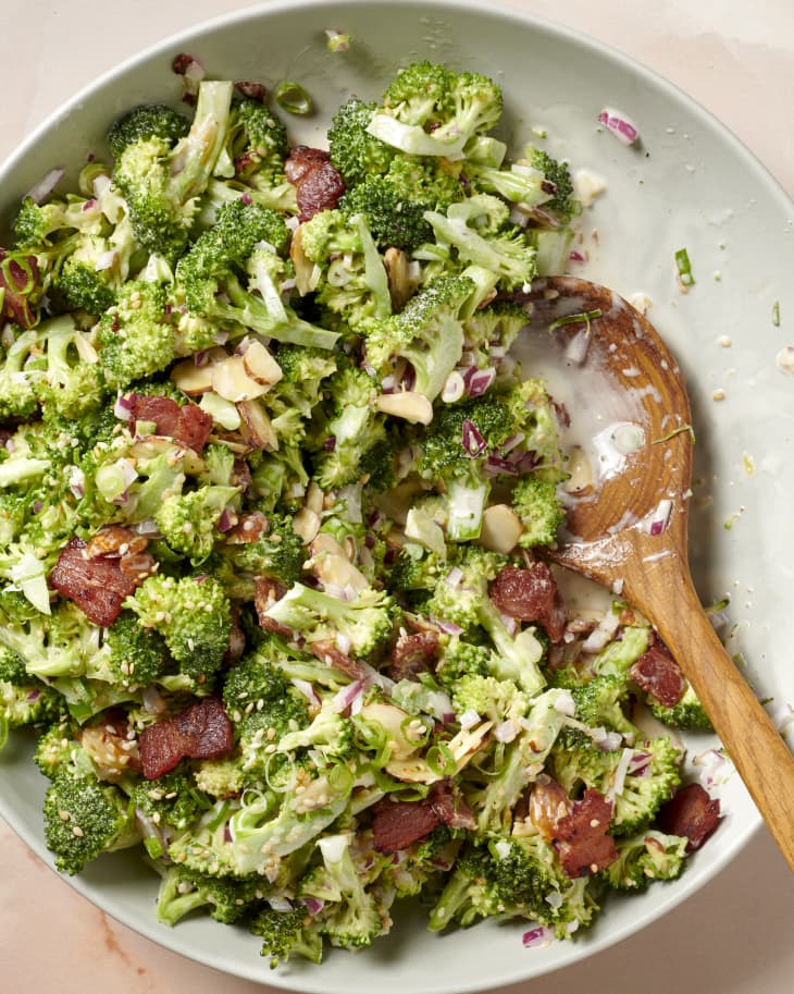 bacon broccoli salad in a serving bowl with some taken out showing the creaminess of the dressing