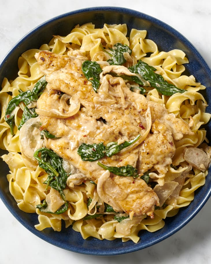 chicken spinach in a bowl served over egg noodles