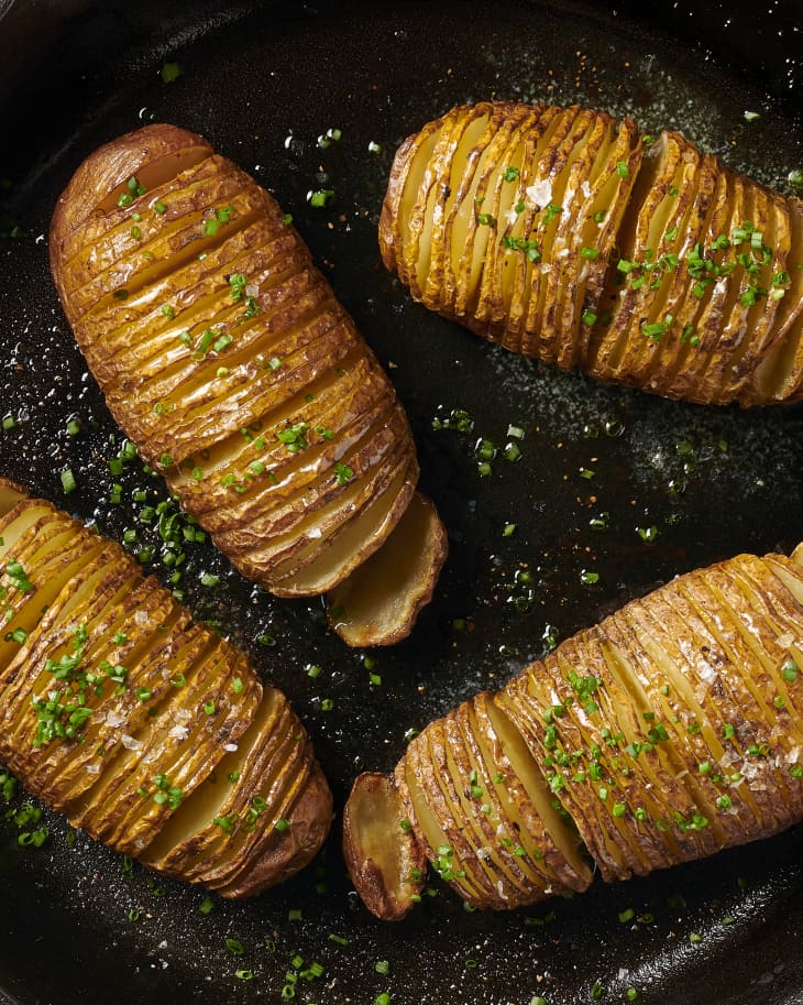 finished hasselback potatoes in a cast iron skillet