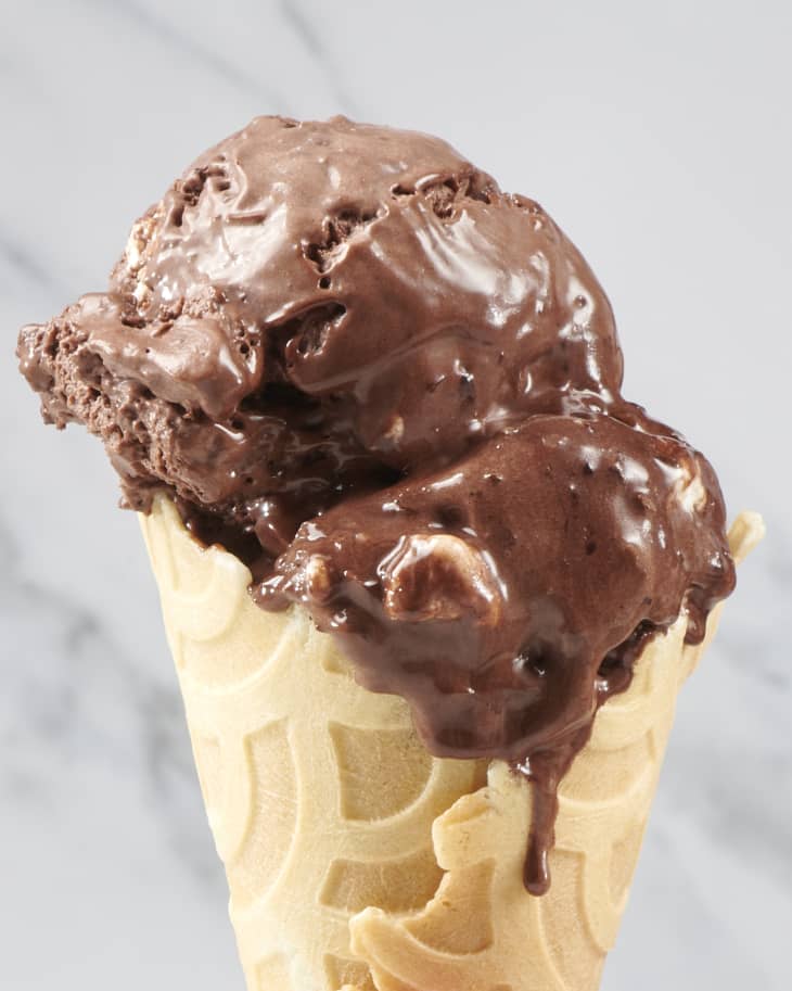 melty rocky road ice cream in a waffle cone