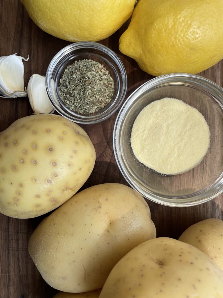 Potatoes, lemons, garlic, and seasoning on a table