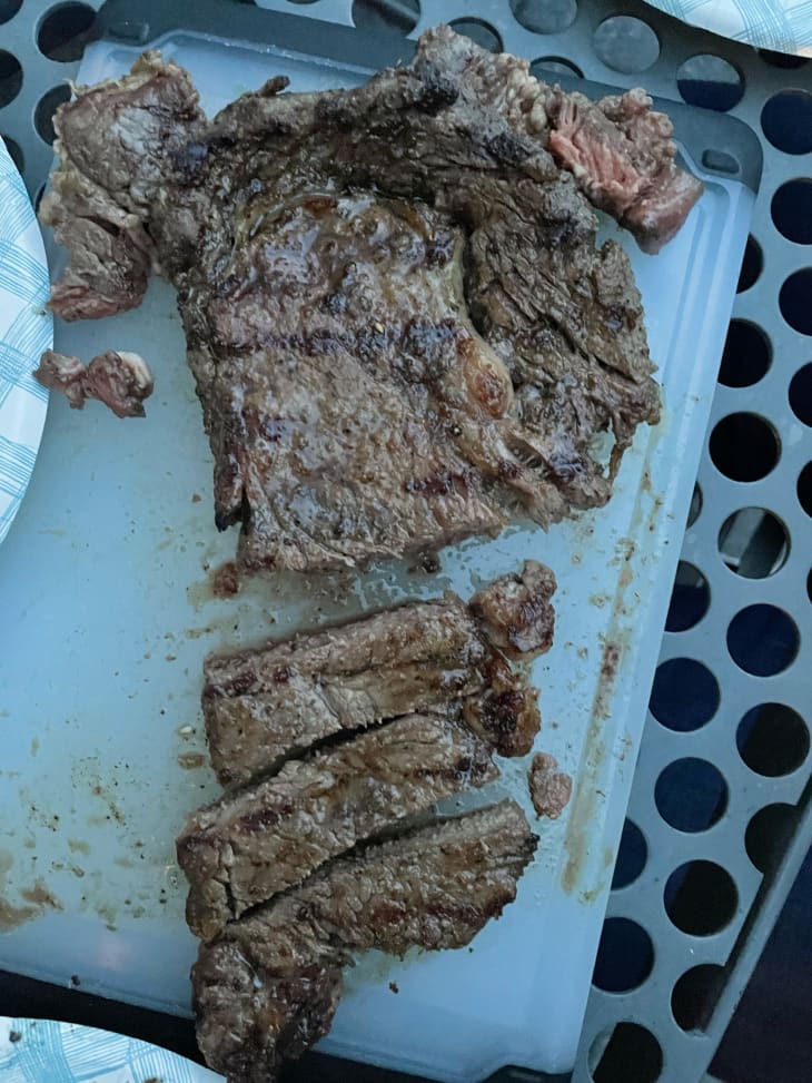 A cut steak on a blue cutting board