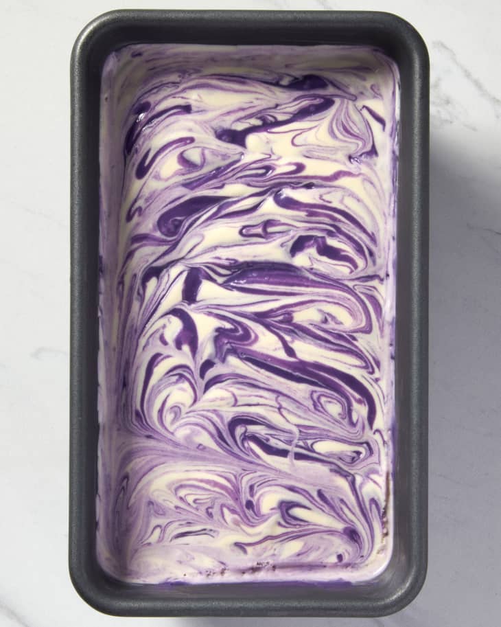 overhead shot of ube swirl ice cream in a metal loaf baking pan