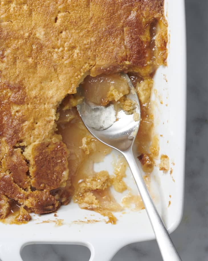 apple dump cake with spoon in and section missing