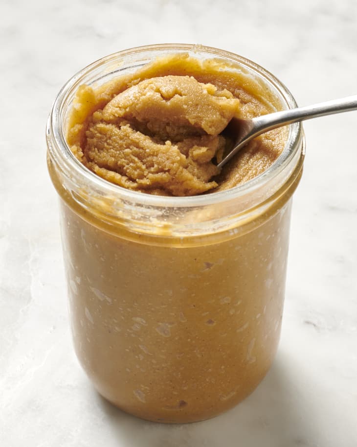 cashew butter in mason jar with a spoon pulling some up