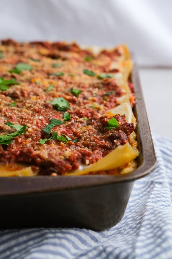 lasagna in pan with parsley on top