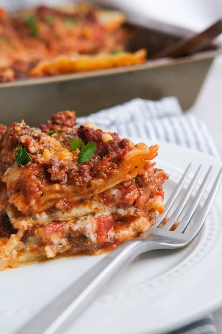 slice of lasagna on a plate with fork