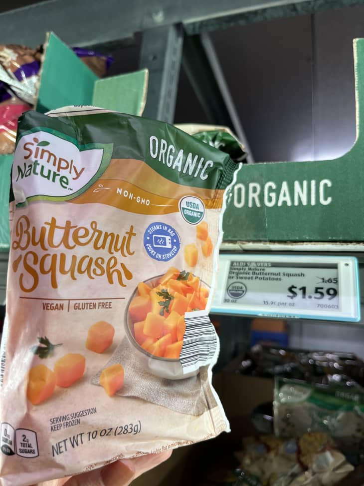 bag of frozen butternut squash in aisle with price sign