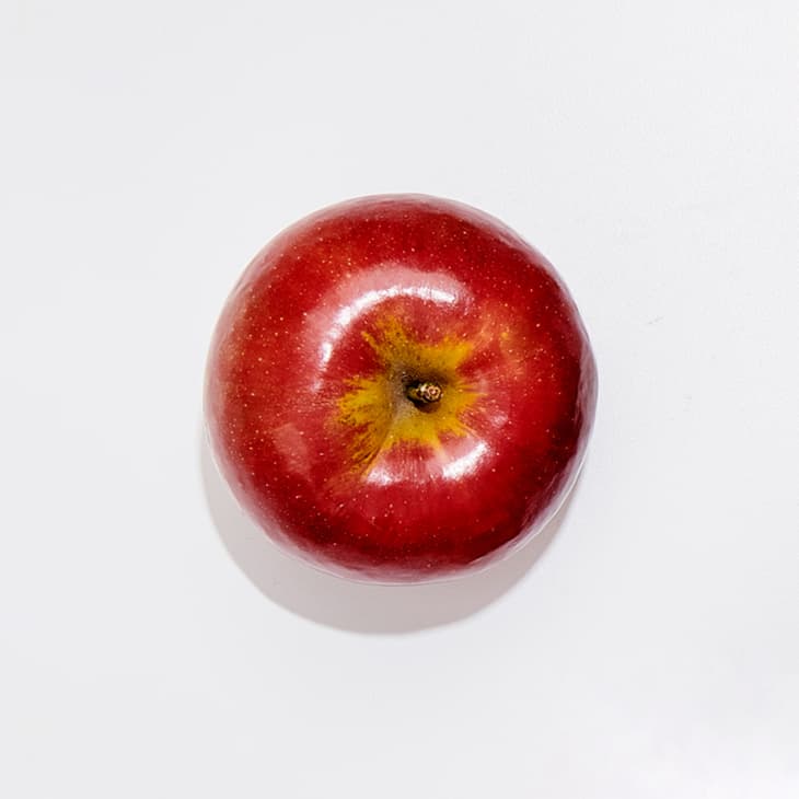A macintosh apple on a white surface.