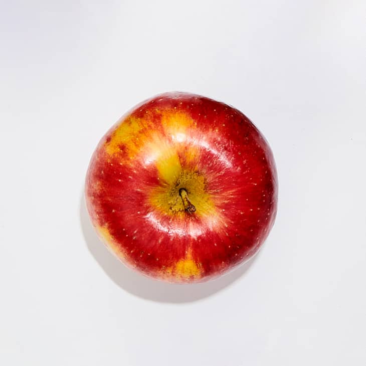 A pazazz apple on a white surface.